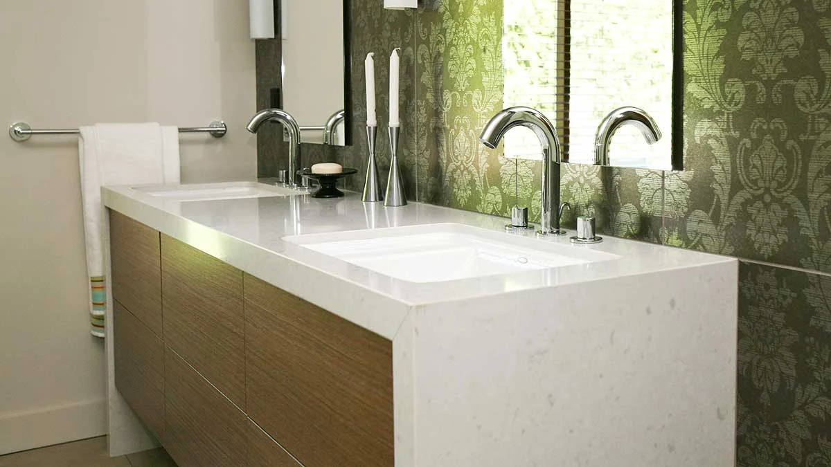 Double-basin vanity with a stone counter and continuous side panel